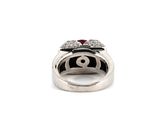 an image of a silver ring with a red stone in the center