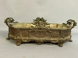 antique brass planter with ornate carvings and handles