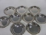 six silver plated ashtrays on a white surface