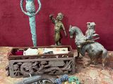 several figurines are sitting on a table next to a red wall