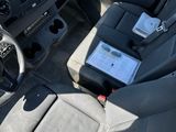 the interior of a car with a steering wheel and dashboard controls
