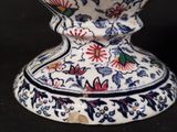 a white vase with a blue and red design on it