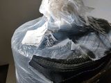 a bag of clothes wrapped in plastic sitting on a table