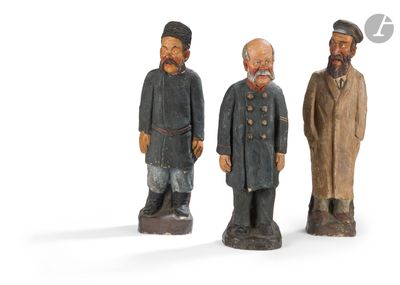 three wooden figurines of three men with beards and hats