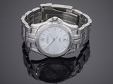 a silver watch with a white face on a black surface