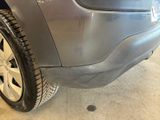 a close up of a car ' s tire on the side of the road