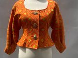 an orange jacket on a mannequin with a white background