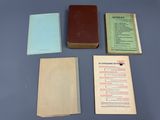 several old books are sitting on a table with a blue background