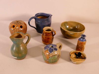 many different types of vases and bowls on the table