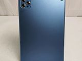 a close up of the back of a blue phone on a white surface