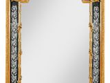 un grand miroir avec un cadre doré et une bordure en noir et blanc