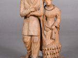 statue of a man and a woman standing on a stone base