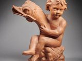 an image of a statue of a child holding a bird