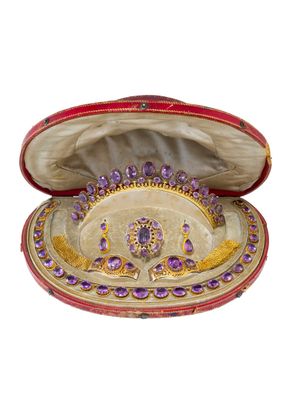 an image of a red and gold jewelry box with purple jewels