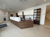a reception desk in a large open space with white walls