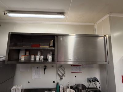 a kitchen with a stainless steel counter top and a sink