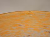 a close up of a yellow bowl on a table