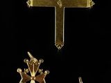 three gold crosses and a crown are shown on a black background