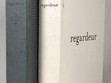 two books sitting next to each other on a white surface