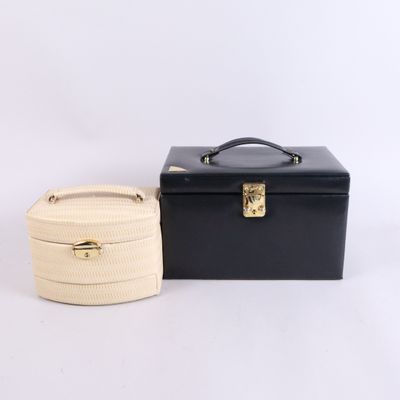 two black and white boxes with handles and a rope wrapped around them