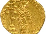 a close up of a gold coin with an image of a man on it