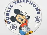 disney mickey mouse public telephone sign on a white wall