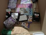 a cardboard box filled with assorted items and a cell phone