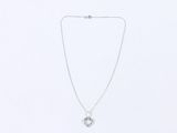 a silver necklace with a heart shaped pendant hanging from it ' s side