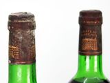 two bottles of wine sitting next to each other on a table