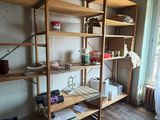 a room with a wooden shelf and a window in it
