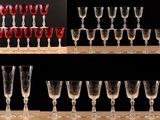 many wine glasses lined up on a shelf