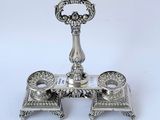 a silver plate with a candle holder on it