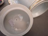 a white bowl with a tag on it sitting on a table