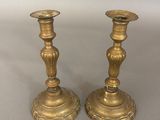 pair of antique brass candlesticks on a white background