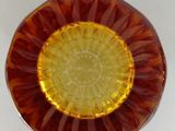 a glass bowl with a yellow and red design on it