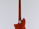 a red electric guitar on a stand against a white background