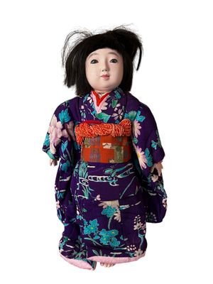 une image représentant une poupée à l'effigie d'une femme vêtue d'un kimono violet