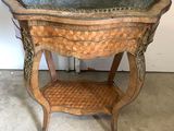 a small wooden table with a glass top on it