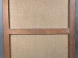 an old wooden frame with a brown canvas on it