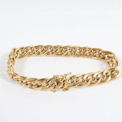 a gold chain bracelet with a diamond clasp