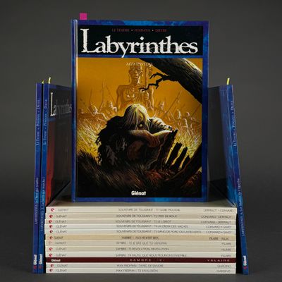 many books stacked on top of each other on a table