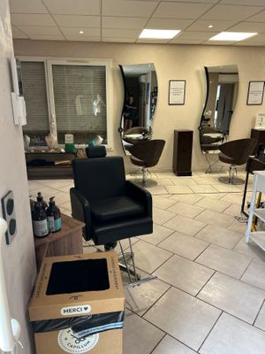 a picture of a salon with a lot of chairs in it