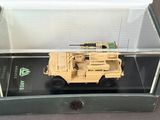 a toy army vehicle in a display case on a table