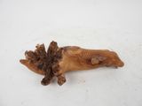 a wooden animal that is laying down on the ground