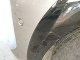 a close up of a car ' s front bumper with a hole in it