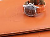 brown leather watch case with a brown watch on top of it