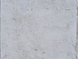 a white tile on the ground with a black cat