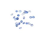 a bunch of blue sapphires on a white surface