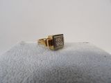 a close up of a gold ring with diamonds on a white surface