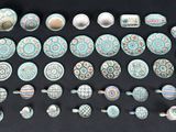 many different types of pottery on a black surface